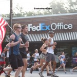 The American flag is carried by a runner on the 4th of July's Peachtree Road Race in Atlanta