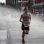 Runners cool off during a hot Peachtree Road Race in Atlanta