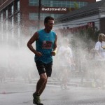 Runners cool off during a hot Peachtree Road Race in Atlanta