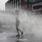 Runners cool off during a hot Peachtree Road Race in Atlanta