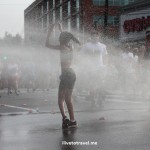 Runners cool off during a hot Peachtree Road Race in Atlanta