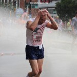 Runners cool off during a hot Peachtree Road Race in Atlanta
