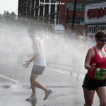Runners cool off during a hot Peachtree Road Race in Atlanta