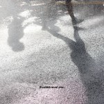 Runner's shadow on the pavement at the Peachtree Road Race in Atlanta
