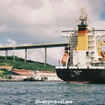 Cargo ship entering St. Anna Bay with the Queen Juliana bridge in the background in Willemstad, Curacao