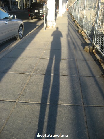 Runner shadow ona sidewalk at sunset